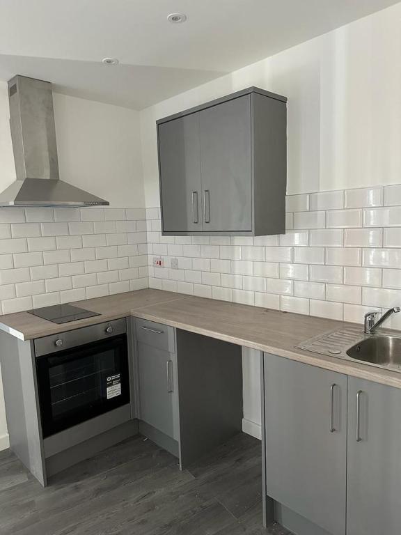 a kitchen with a counter top and a sink at 1GS Luxury London Road Apartments in Leicester