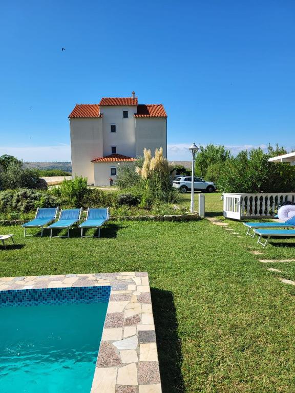 a villa with a swimming pool and a house at Apartmani Manuela Ljubač in Ljubač