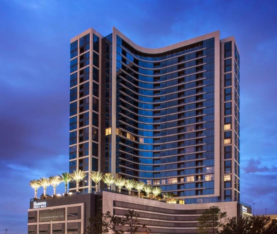 a tall building with lights on top of it at Hanover Post Oak in Houston