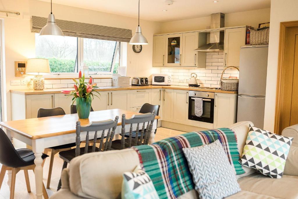 a kitchen and living room with a couch and a table at Galloway View in Castle Douglas
