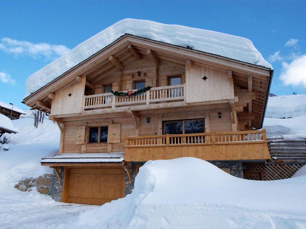 a log cabin in the snow with a pile of snow at Chalet Le Grand-Bornand, 6 pièces, 12 personnes - FR-1-467-44 in Le Grand-Bornand