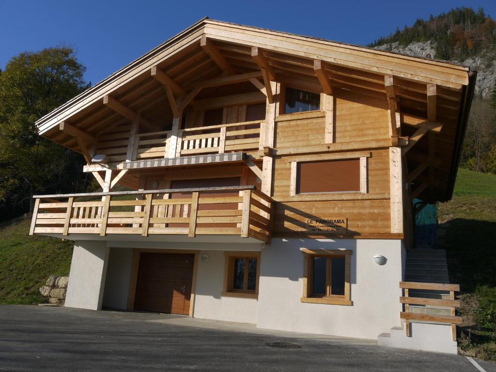 a large wooden house with a balcony on top at Chalet Le Grand-Bornand, 5 pièces, 10 personnes - FR-1-467-71 in Le Grand-Bornand
