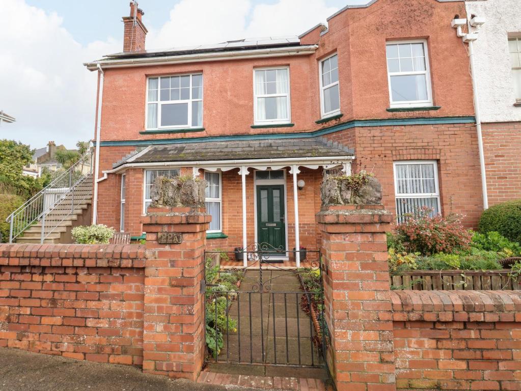 a red brick house with a gate at Tidal Reach in Paignton