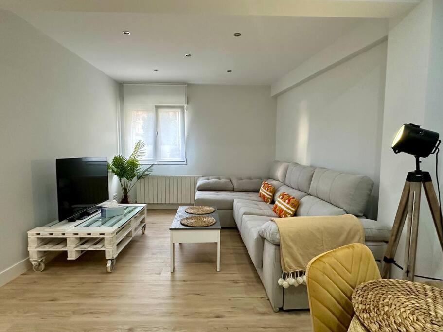 a living room with a couch and a coffee table at Apartamentos 2K - Apartamento en el centro de Castro Urdiales reformado in Castro-Urdiales