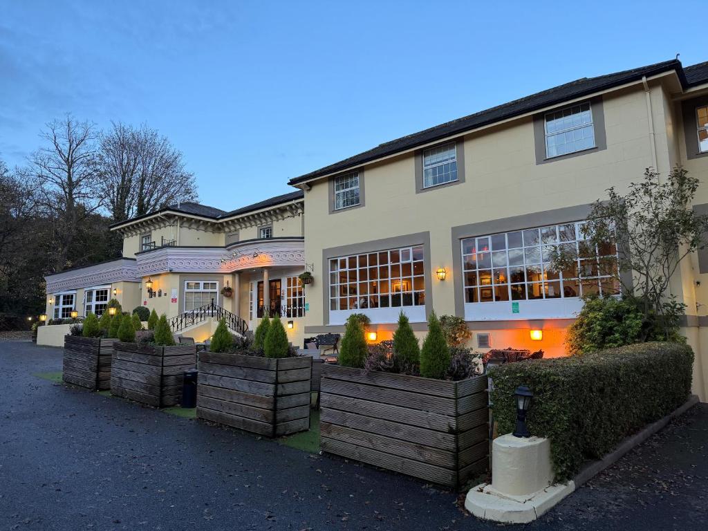 a large building with plants in front of it at Reigate Manor Hotel in Reigate