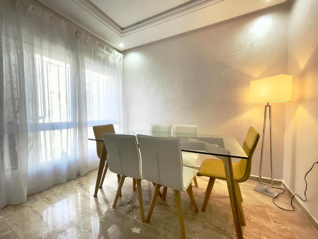 a dining room with a table and chairs at Appartement Tanger Moulay Ismail in Tangier