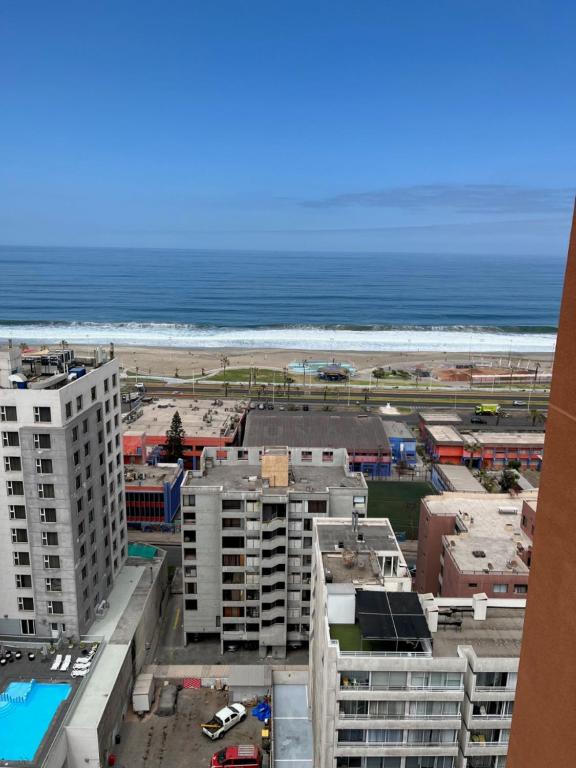 a view of the beach from the balcony of a building at Playa Brava - Iquique in Iquique