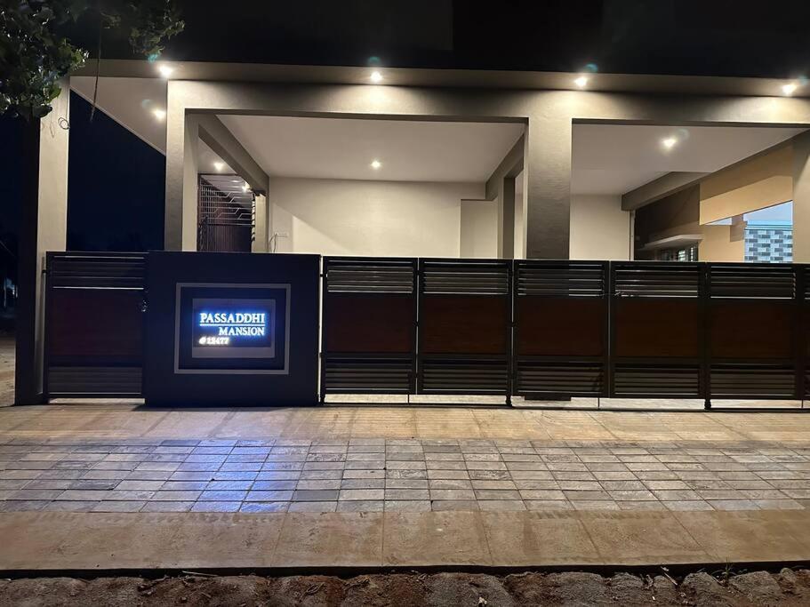 a building with a sign on the side of it at Passaddhi Serviced Apartment G1 in Mysore