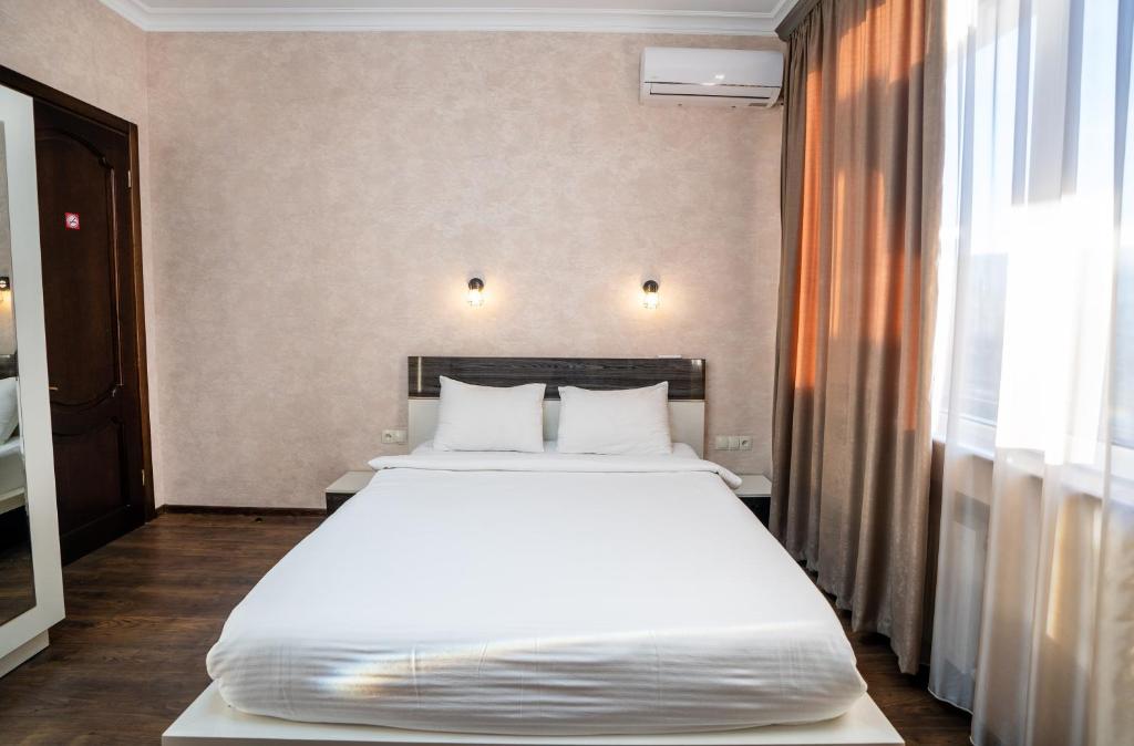 Postel nebo postele na pokoji v ubytování Siberia Hotel