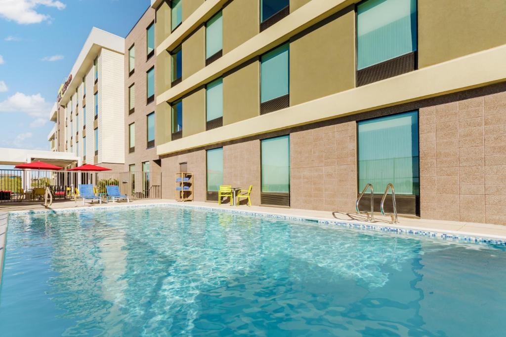 a swimming pool in front of a building at Home2 Suites By Hilton Lake Mary Orlando in Lake Mary