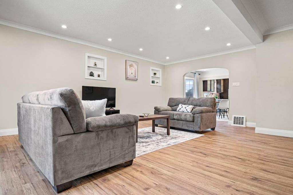 a living room with two chairs and a fireplace at Fields Inn Executive Townhouse in Kingston