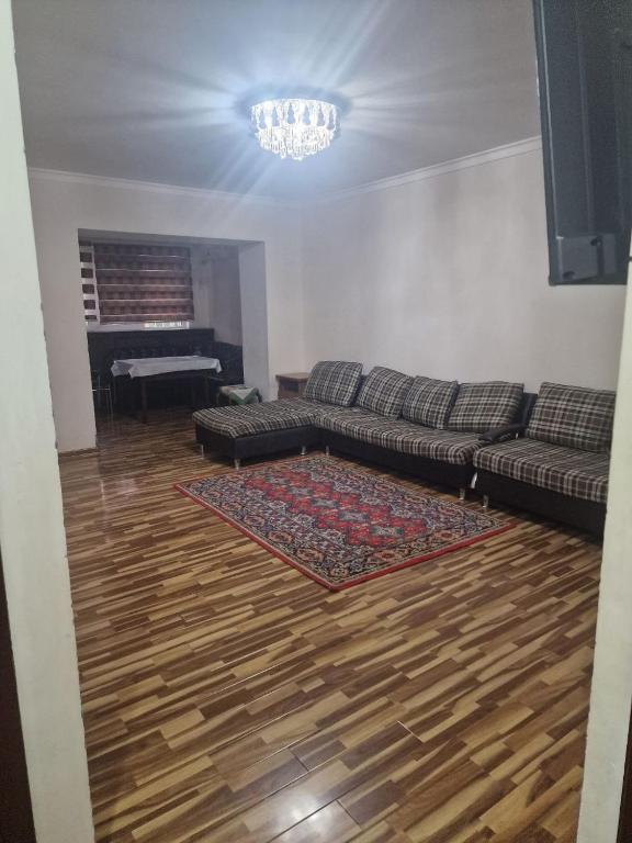 een woonkamer met een bank en een hardhouten vloer bij Buz-2 in Yalanghoch