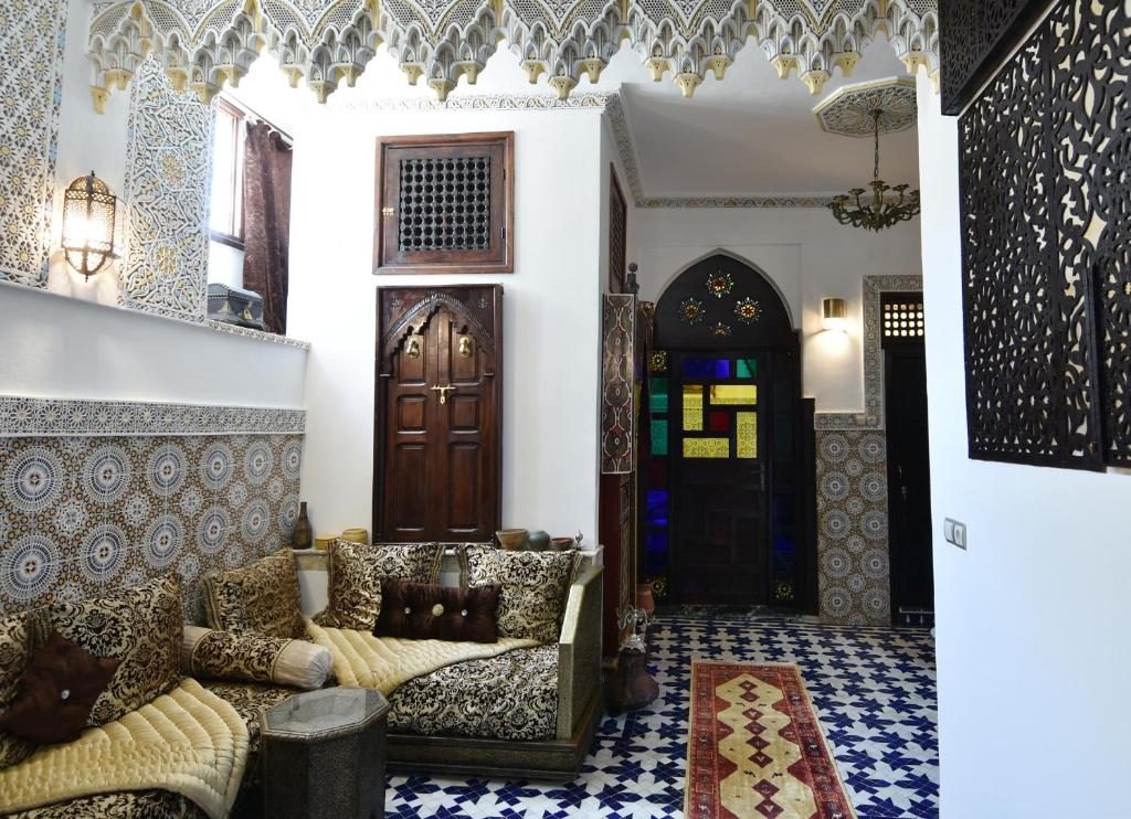 a living room with a couch and a door at Dar Aya Fes in Fez