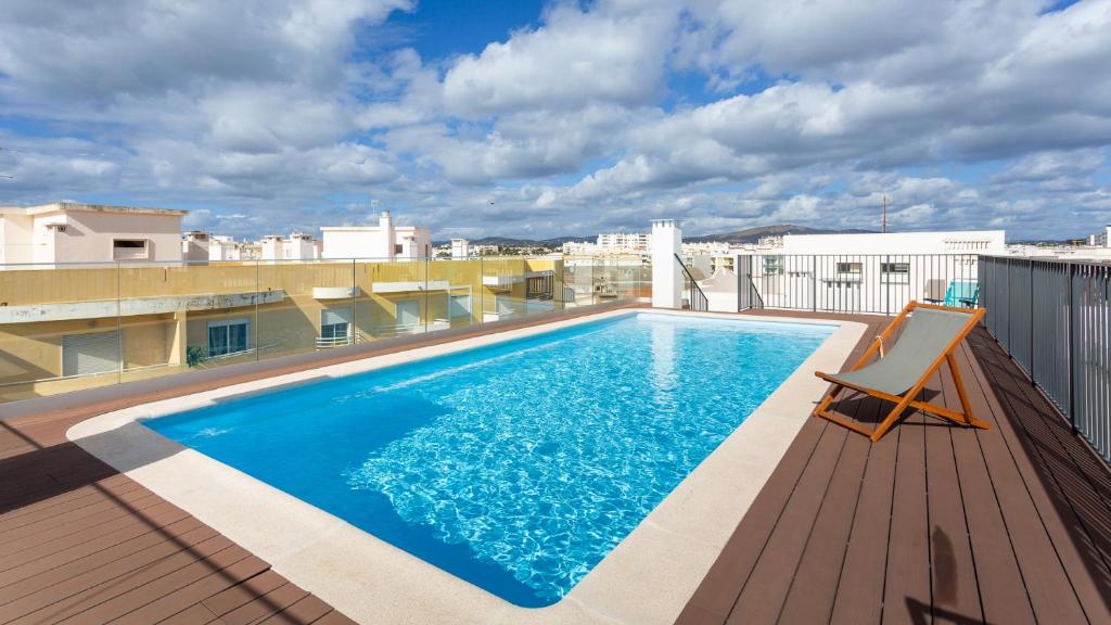 a swimming pool on the roof of a building at Brand New 2 BDR Flat W/Rooftop Pool by LovelyStay in Olhão