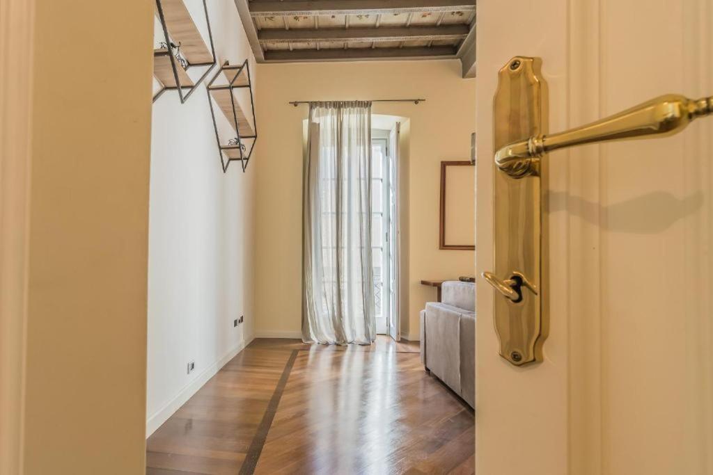 eine offene Tür zu einem Zimmer mit einem Wohnzimmer in der Unterkunft Thea - Centro Storico in Monza