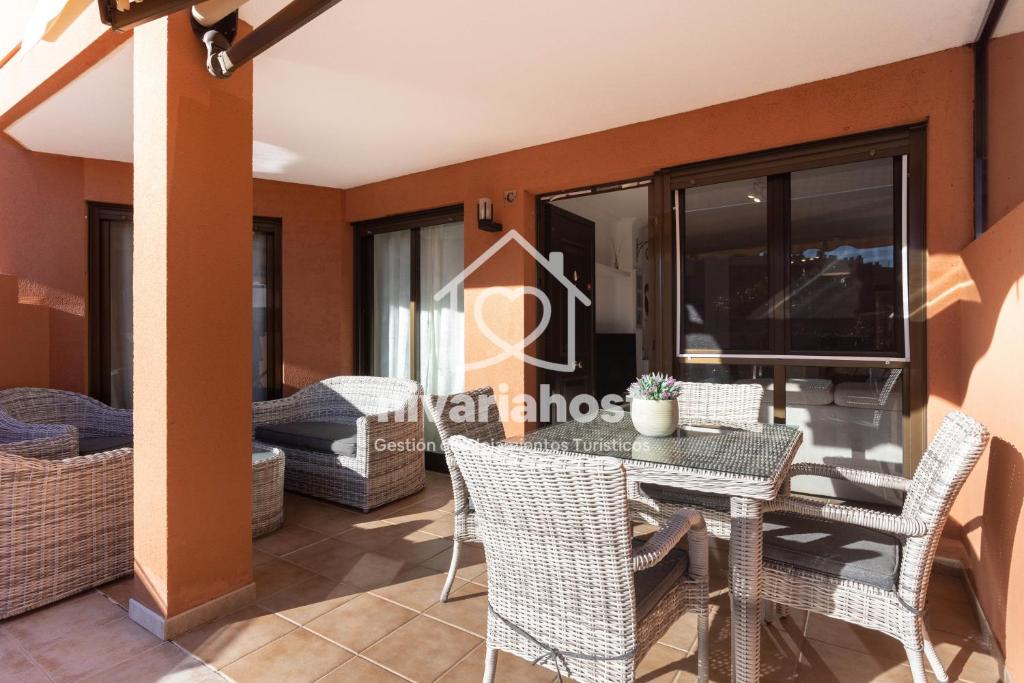 a room with a dining table and chairs on a balcony at Sunset View La Tejita, by Nivariahost in Granadilla de Abona