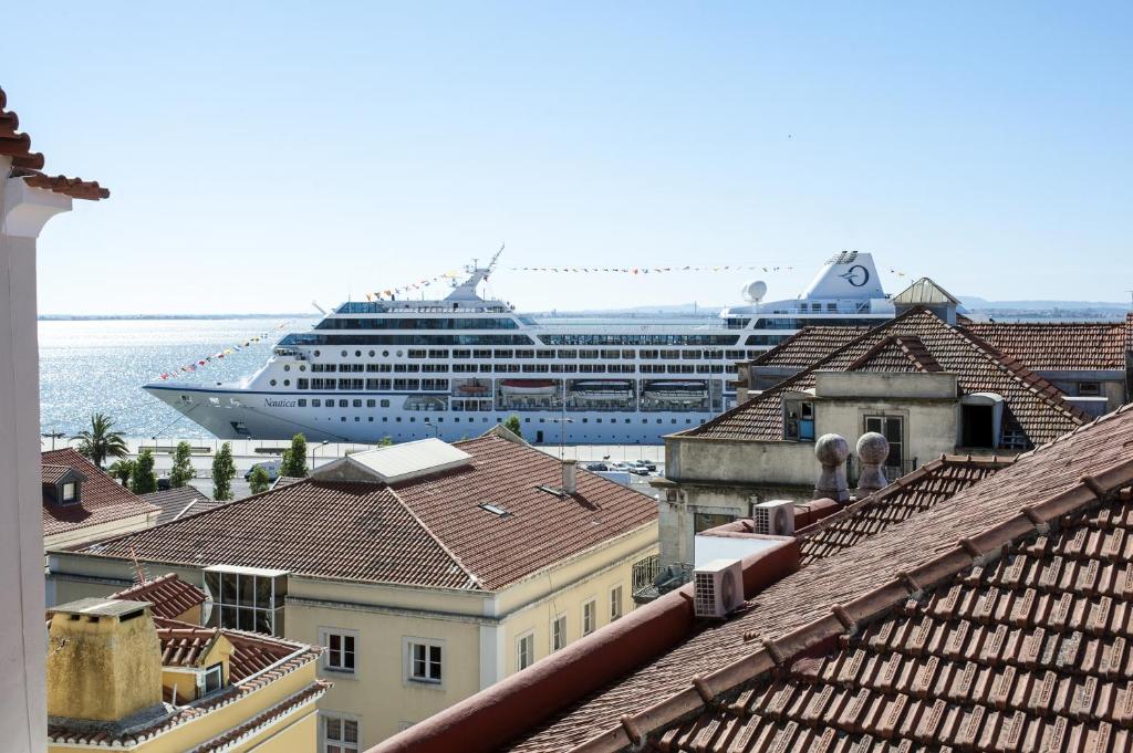 una nave da crociera è ormeggiata in acqua di Stay local in Alfama! Deolinda central Home, amazing view a Lisbona