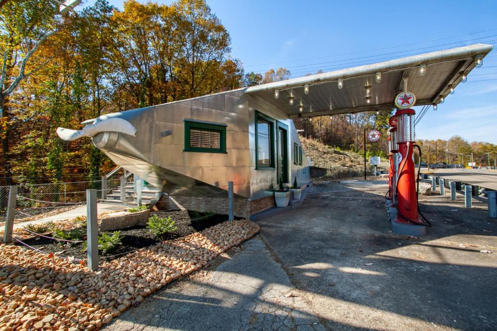 a small building with a boat on the side of it at Airplane Filling Station -Unique Stay in Knoxville in Knoxville