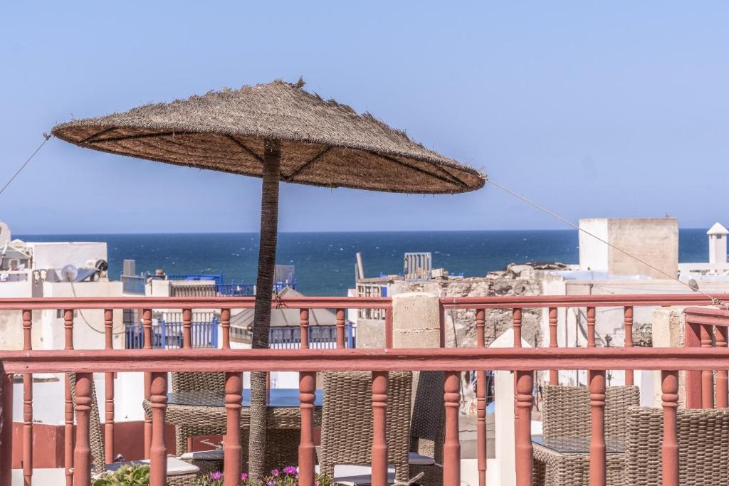 a large umbrella sitting on top of a balcony at Villa Garance in Essaouira