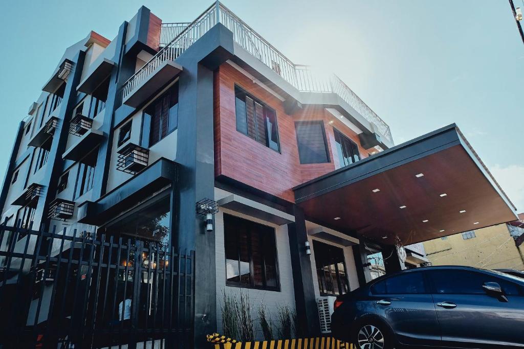 Grayhouse Inn Tagaytay في تاجيتاي: منزل فيه سيارة متوقفة أمامه
