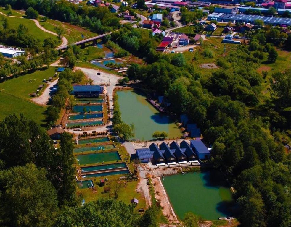an overhead view of a park with two ponds at Pastravaria Zavoi in Valea Danului