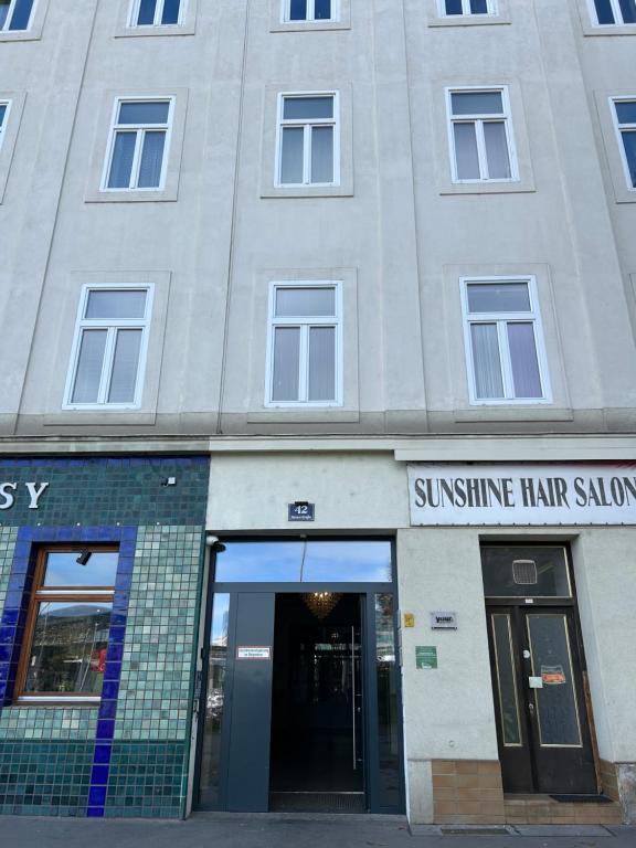 a building with the entrance to a sunshine hair salon at Vienna Prater Apartment in Vienna