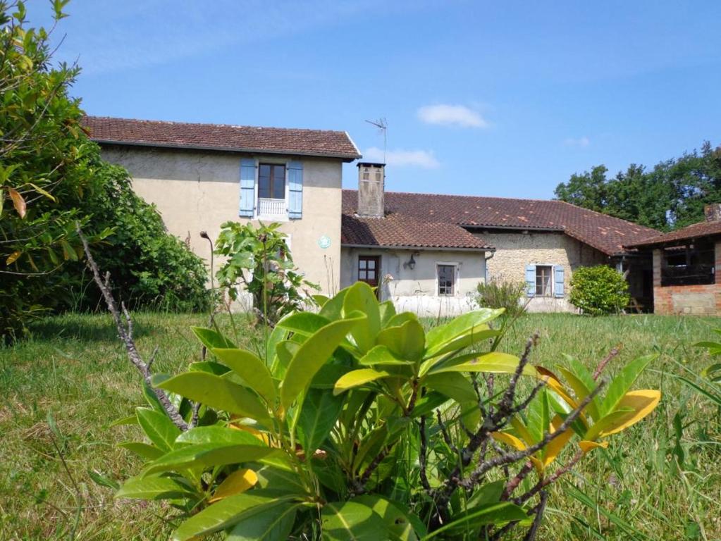 a house with a bush in front of a yard at Laborde in Mimbaste