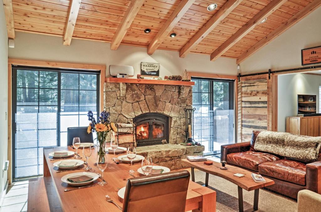 a living room with a table and a fireplace at Truckee Northstar Family Home By Jaeger Retreat in Truckee