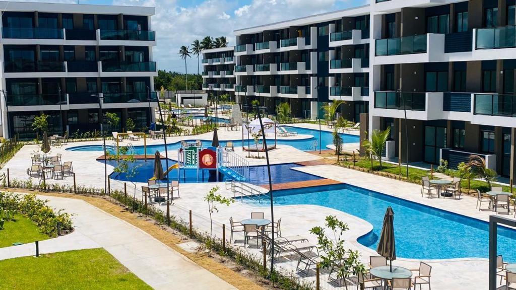 an image of a swimming pool in a apartment complex at Makia beach Experience in Porto De Galinhas