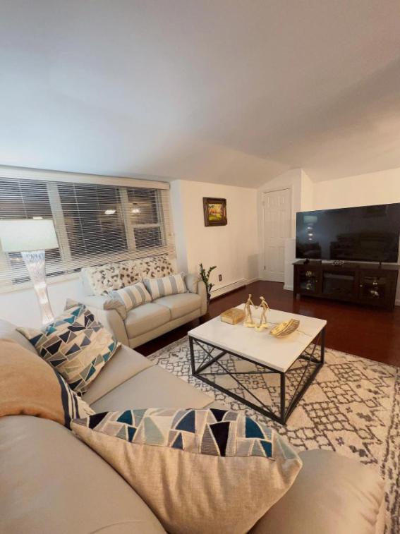 a living room with a couch and a table at Trendy 2BR apartment in NYC! in New York