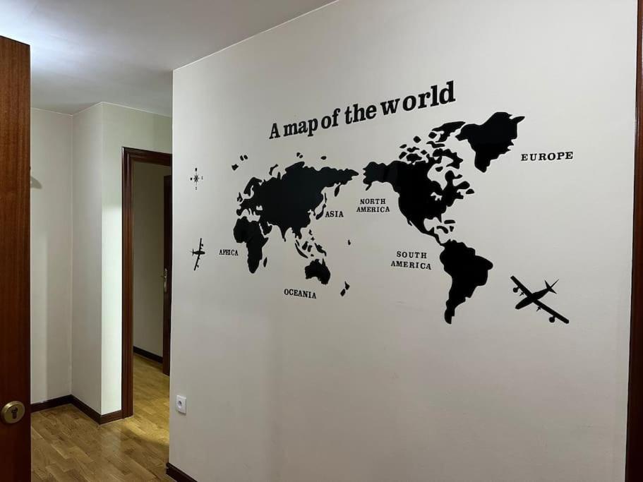 a map of the world wall sticker in a hallway at Apartamento con vistas a la montaña in Infiesto