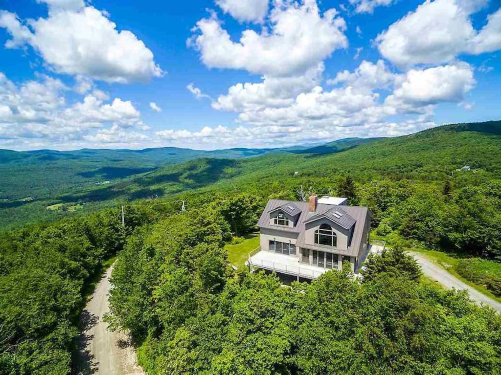 an aerial view of a house in the mountains at Moon Hill Retreat in Londonderry