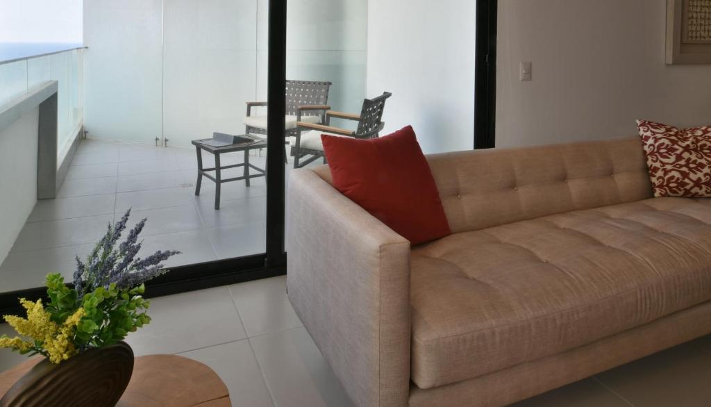 a living room with a brown couch and a table at Edificio Poseidon Depto. Vista Lateral al Mar in Manta