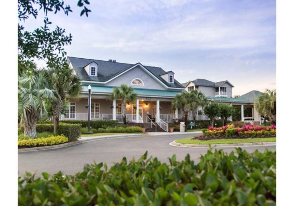 a large house with a driveway at Myrtle Beach Bike Week - Spring Rally - Deluxe Studio Villa Retreat Resort - Special Offer Now! in Myrtle Beach