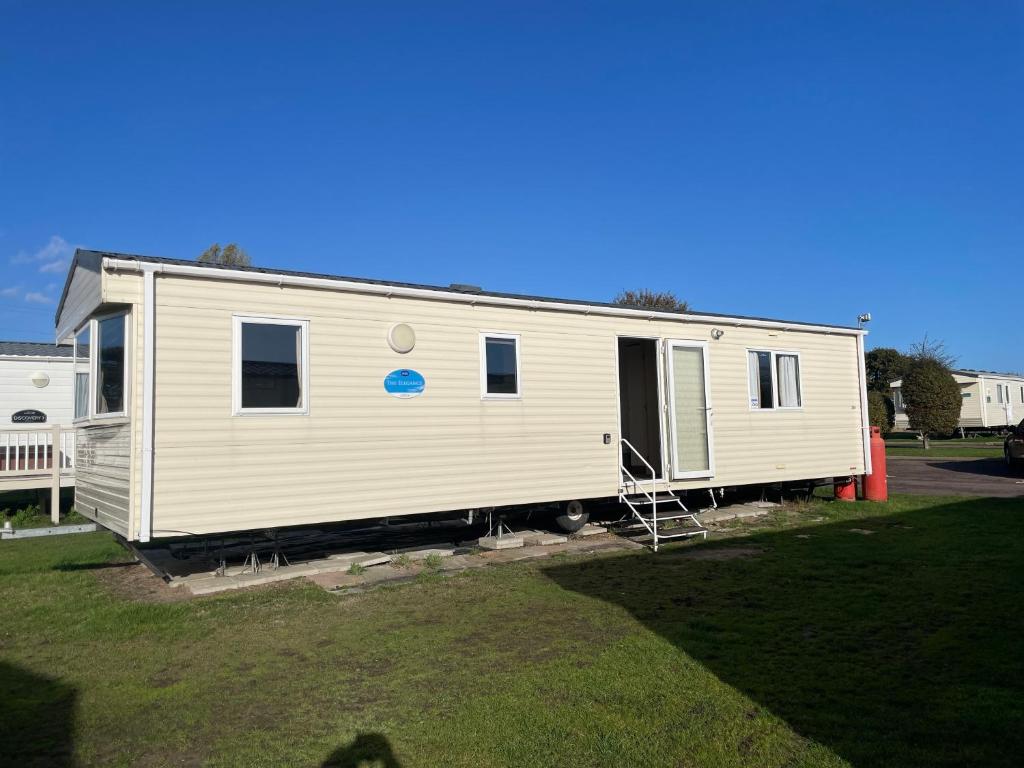 a white mobile home sitting in a yard at Captivating 2-Bed Caravan in Clacton-on-Sea in Clacton-on-Sea
