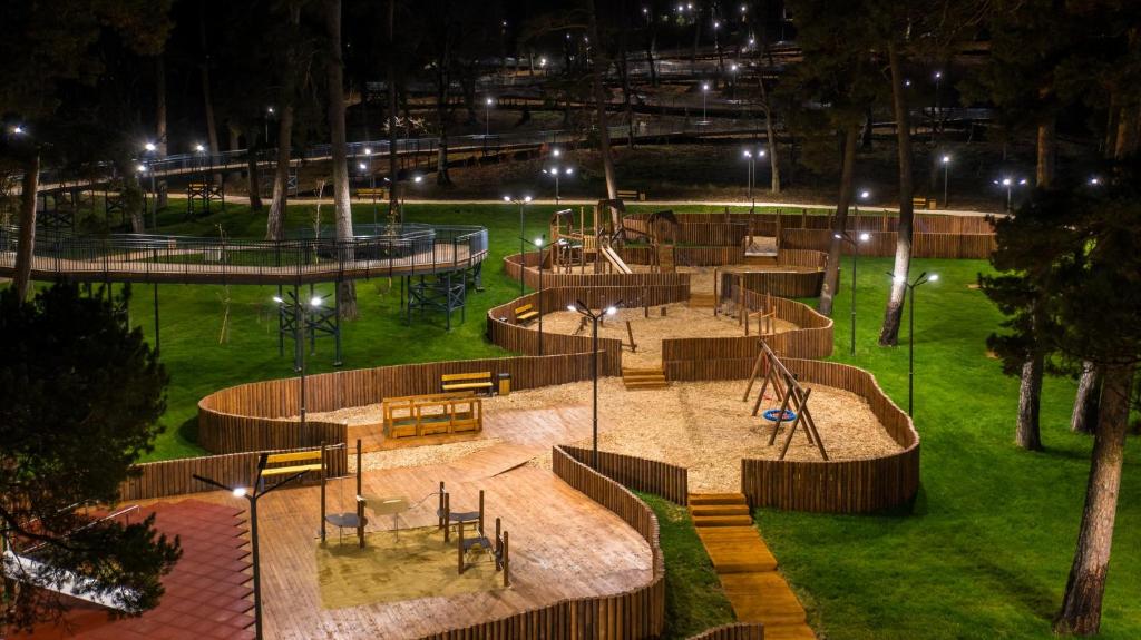 a park at night with a playground with tables and benches at Villa Bakuriani in Bakuriani