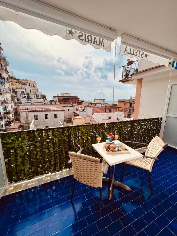 a table and chairs on a balcony with a view at Brezza Marina Guest House in Maiori