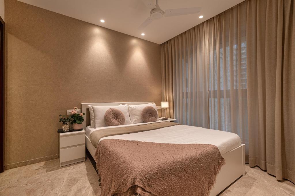 a bedroom with a large bed and a window at One Bedroom Apartment - Regent Hills, Mumbai Powai in Mumbai