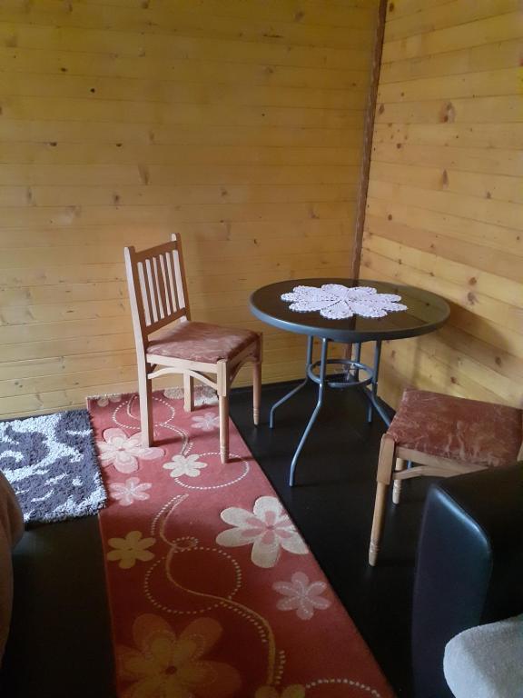 a room with a table and a chair and a table at Guesthouse Dioni in Valbonë
