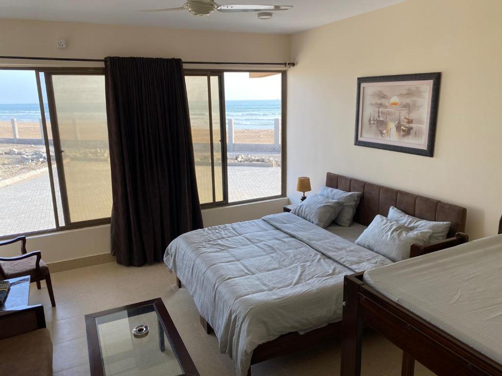 a bedroom with a bed with a view of the ocean at Kundmalir Gold Coast Beach Resort 