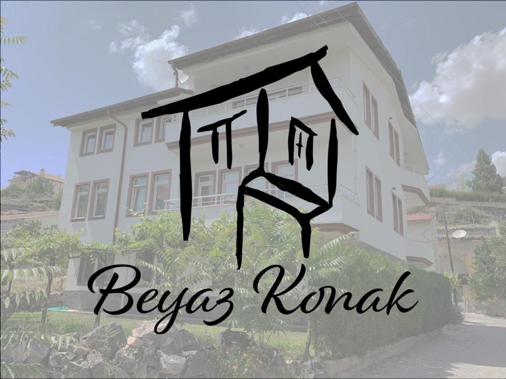 a drawing of a house in front of a building at Beyaz Konak Pansiyon 2 in Gülşehir