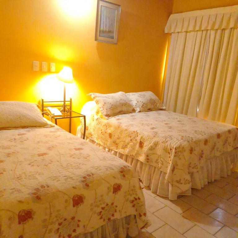 Postel nebo postele na pokoji v ubytování Hotel Santo Domingo