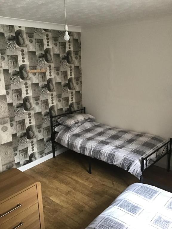 a bedroom with a twin bed and a wall with baseball posters at Kings Lynn 1 in Kings Lynn