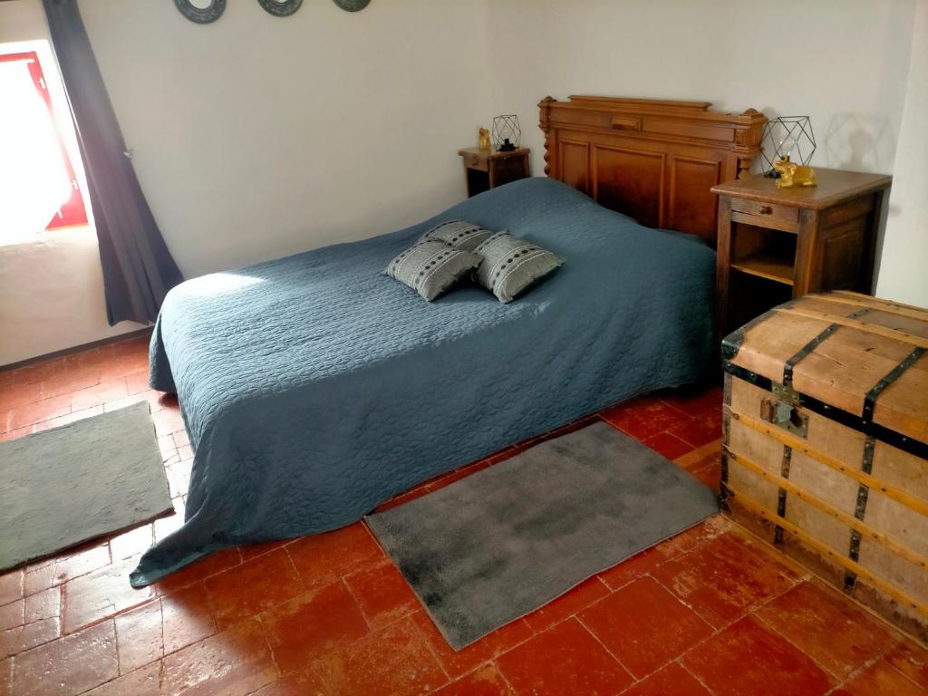 a bedroom with a bed with two pillows on it at Chez Nath et Oli in Caunes-Minervois