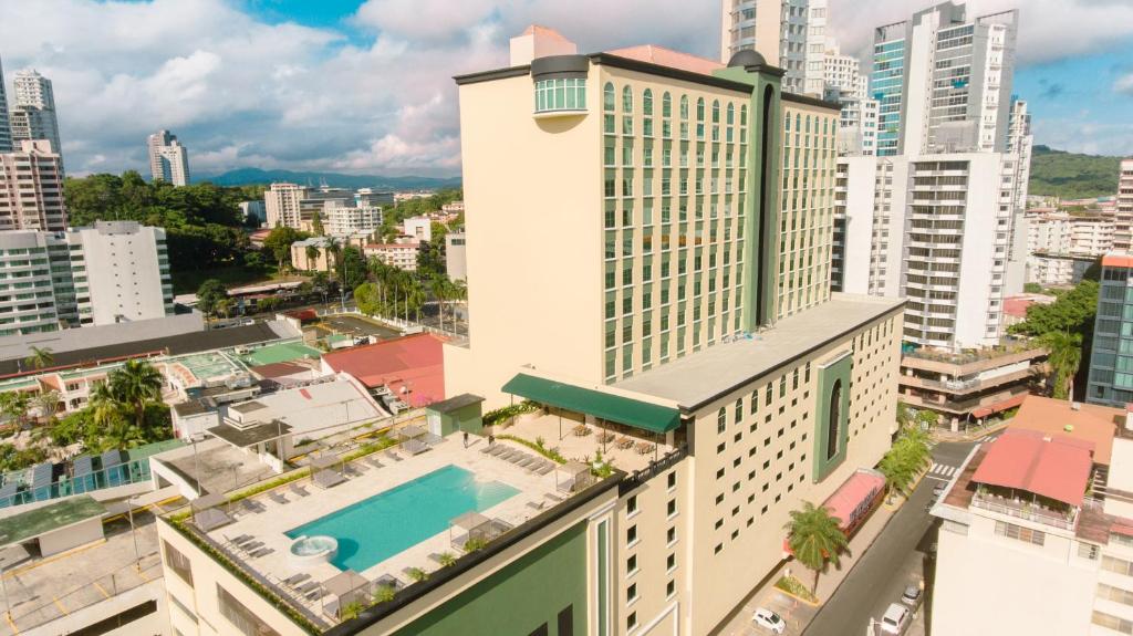 an aerial view of a building with a swimming pool at Waymore Hotel Spa & Casino in Panama City