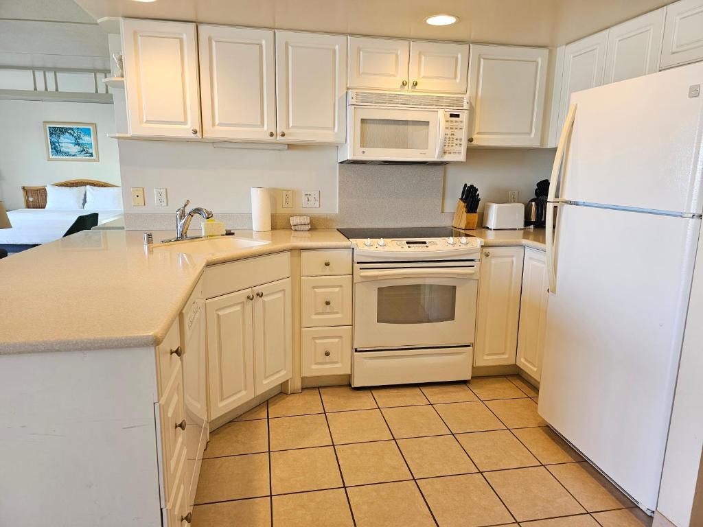uma cozinha com electrodomésticos brancos e um frigorífico branco em Ilikai Tower 1533 Yacht Harbor View 1BR em Honolulu