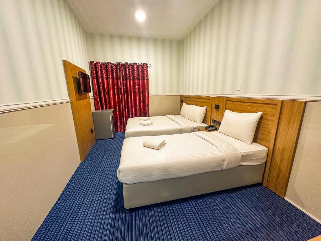 Postel nebo postele na pokoji v ubytování TAMARIND HOTEL