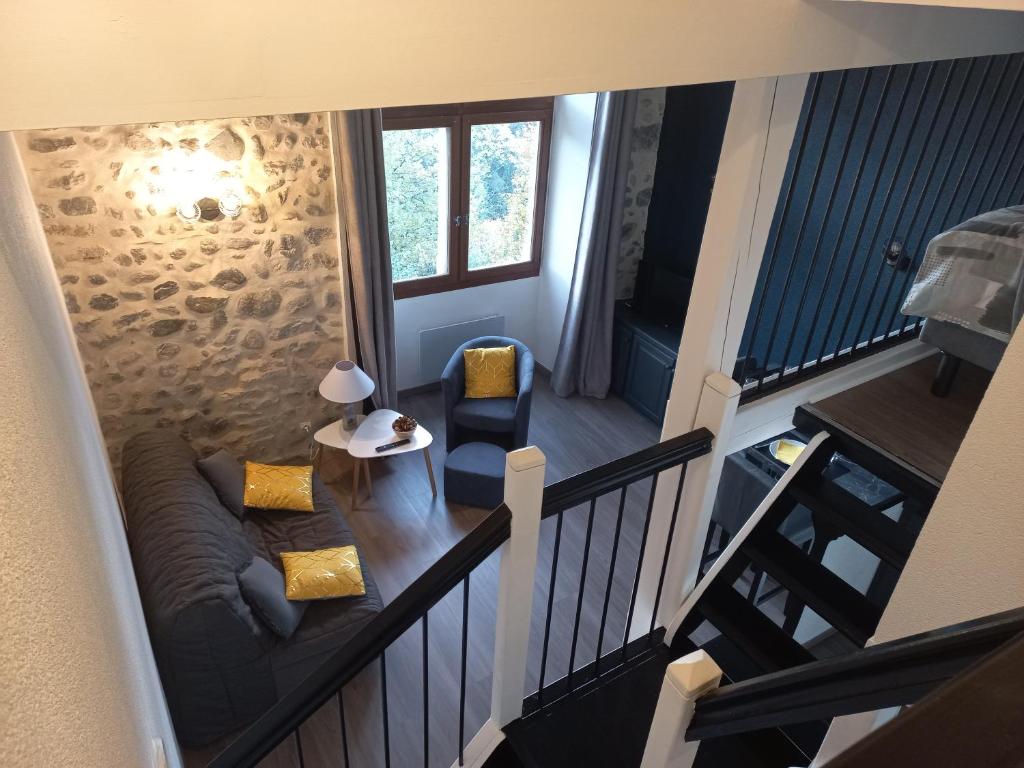 an overhead view of a living room with a couch and a table at Le Belvédère de la grand croix dans le chateau d'uriage in Saint-Martin-dʼUriage