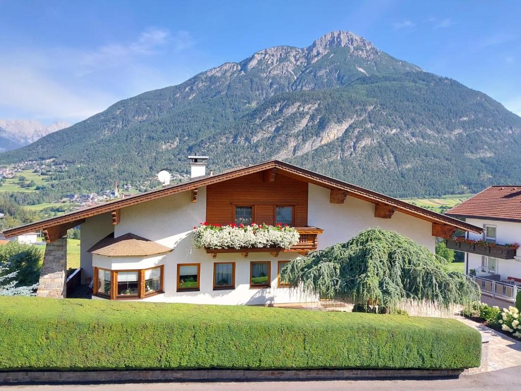 a house with a mountain in the background at Apart Franzi in Arzl im Pitztal
