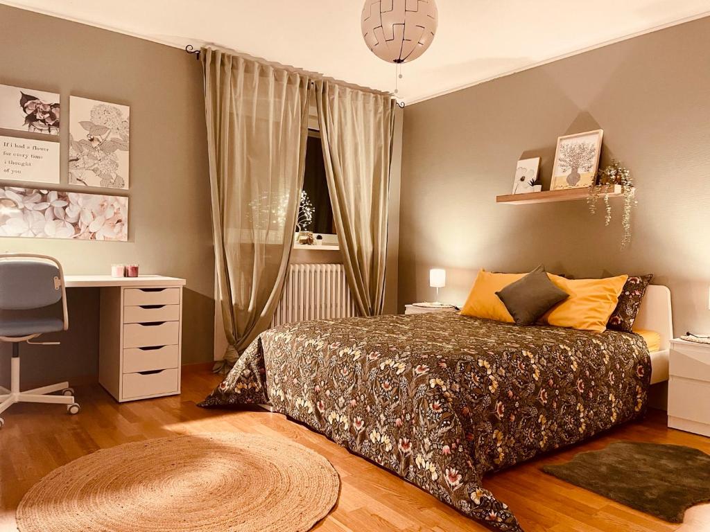 1 dormitorio con cama, escritorio y ventana en Guest House, en Luxemburgo
